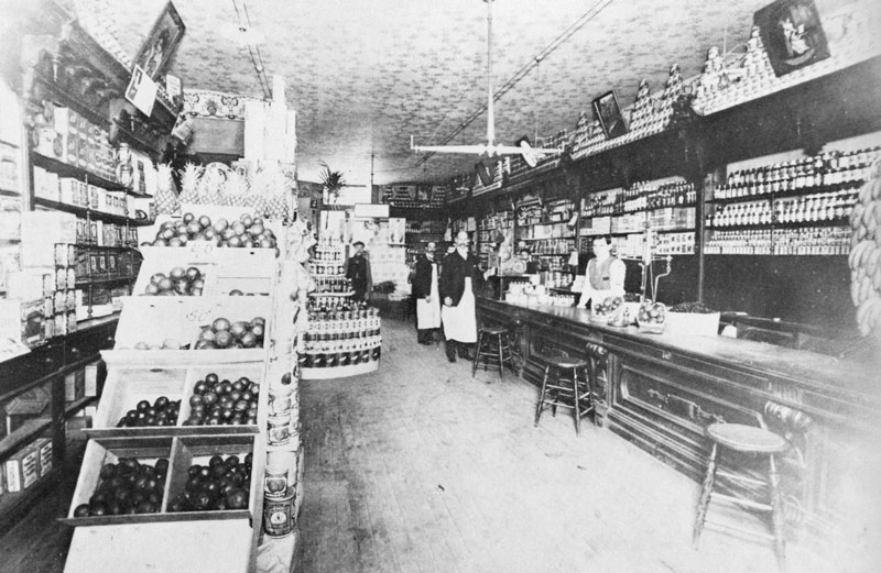 City Grocery in 1908, Queen and Walton street, with W.D. Stephens in front and Leo Greenaway behind the counter.